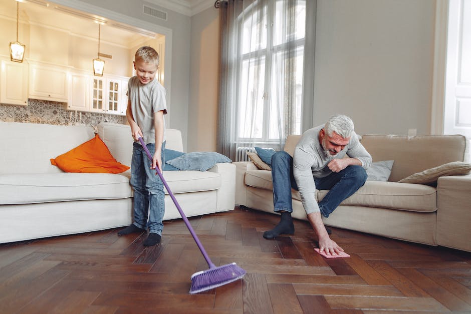 A grandfather and grandson enjoy quality time cleaning their living room together.
